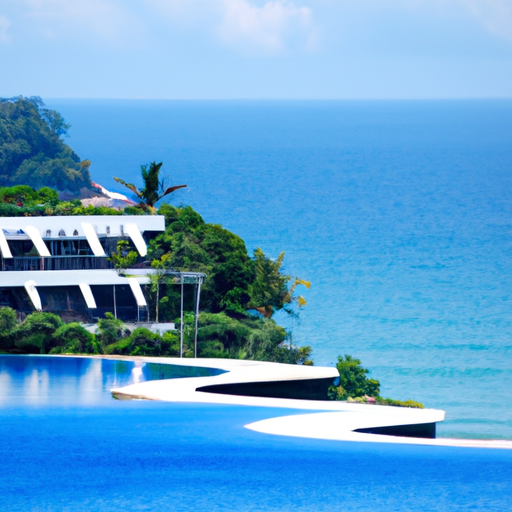 A panoramic view of a luxury hotel in Phuket, with its infinity pool blending into the azure sea.